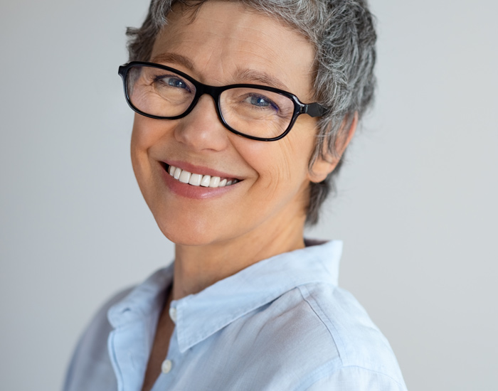 mature woman in glasses smiling