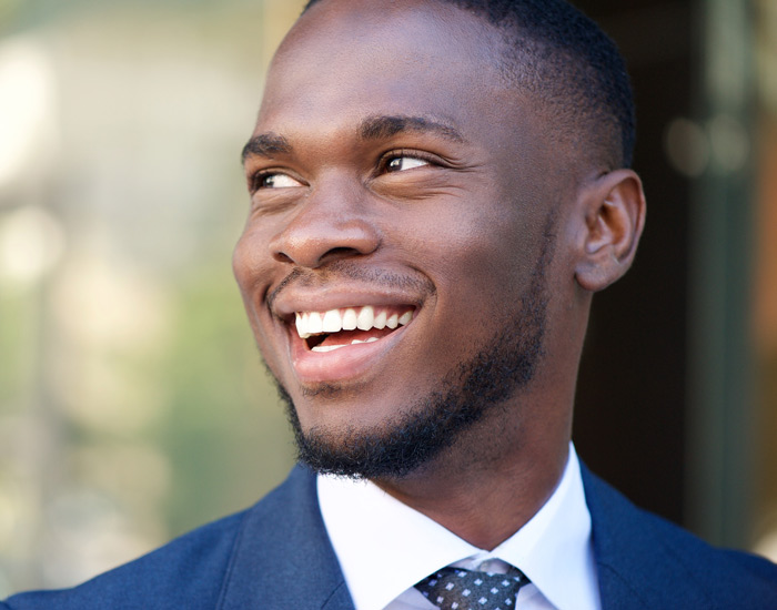 man in blue suit smiling